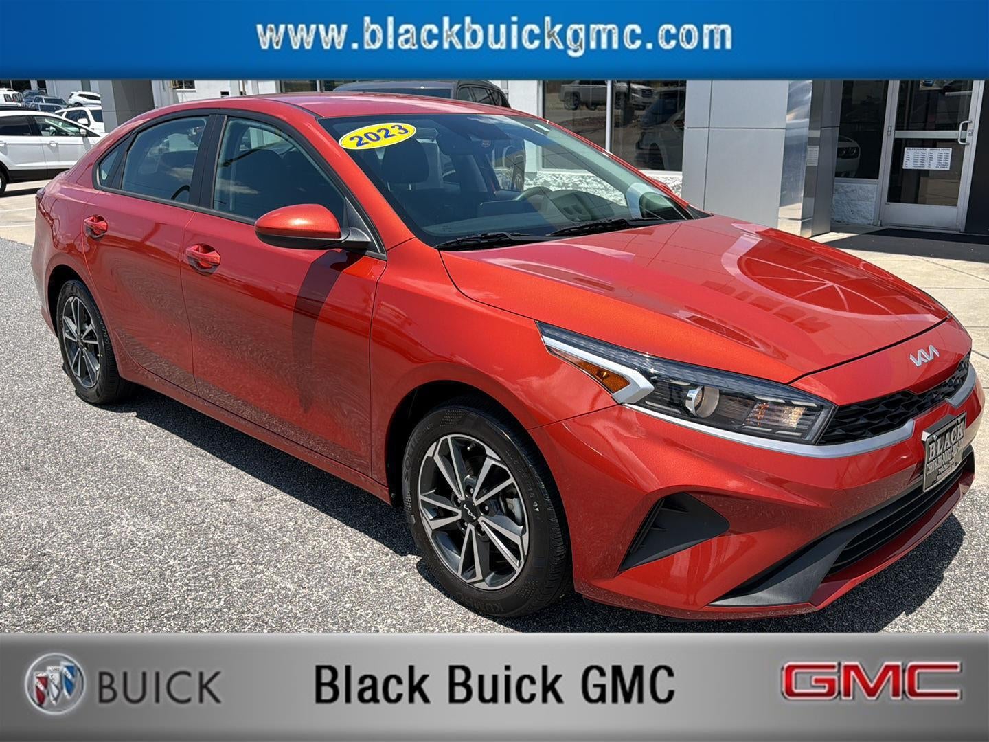 2023 Kia Forte LXS in Fire Orange — front three-quarter view